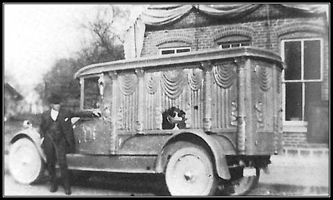 L.O. Wertenberger & his first motorized hearse in 1925  in front of Laketon Harware Store